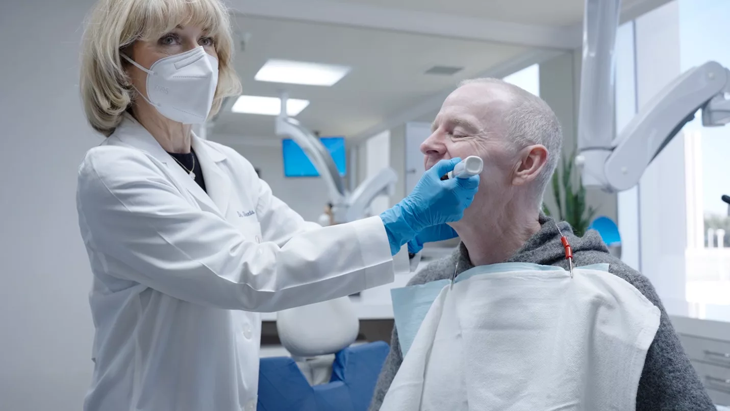 Clinician measuring a patient’s teeth with InnerView